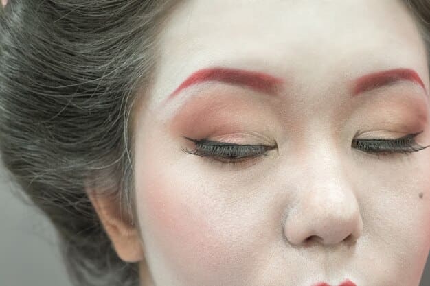 A close-up shot of a woman's eye with subtle Korean drama-inspired makeup. She has a light brown eyeshadow blended softly into her crease, a thin brown eyeliner wing, and curled lashes. The overall look is natural and flattering.