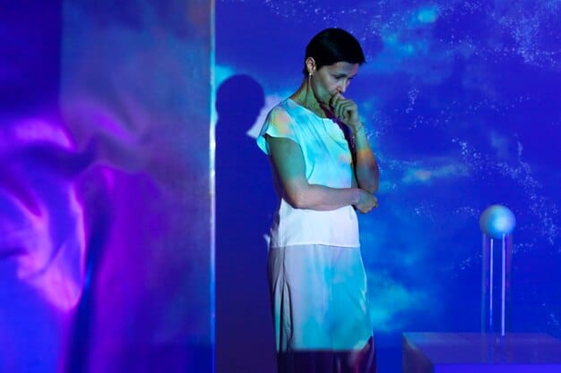 A vibrant performance shot of an emerging artist singing a K-drama OST on stage, bathed in colorful stage lights. The artist's expression should be passionate and engaging, capturing the energy and excitement of live performance. The audience can be visible in the background, showing their enthusiastic support.