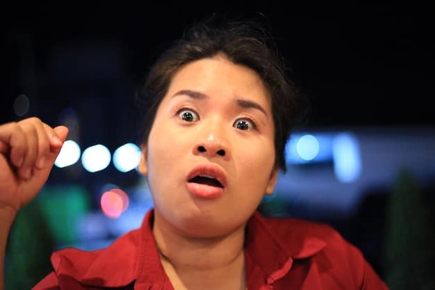 A close-up shot of a Korean actor on a talk show, smiling and confidently answering a question in English. The background shows the talk show set with a live audience.