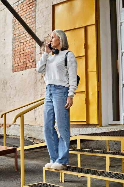 A person in a casual yet stylish K-drama-inspired outfit, featuring an oversized knit sweater and wide-leg jeans, enjoying a walk in a cozy, urban setting, showcasing the wearability of the trend.
