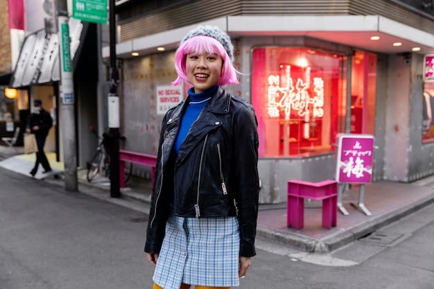 A street style shot in Shibuya, Tokyo. A young woman is wearing an oversized pastel pink coat over a bright yellow dress. She is accessorized with chunky white sneakers and a holographic crossbody bag.