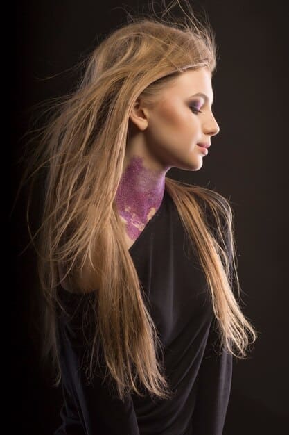 Profile shot of a woman with wavy hair dyed in a gradient of natural brown to ash blonde, styled with subtle waves and a side braid, inspired by a modern J-drama character.
