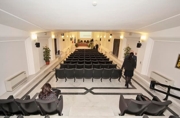 A wide shot of a grand, luxurious setting, possibly a corporate boardroom or a family estate, signifying the wealth and power dynamics at play in 