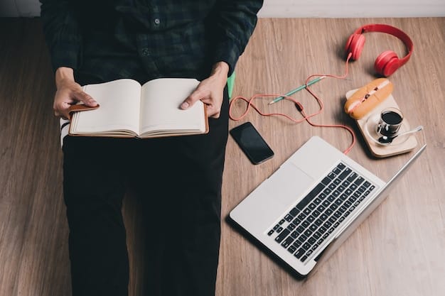 A person typing intently on a laptop, surrounded by theatre-related books and notes, illustrating the process of writing a digital drama review.