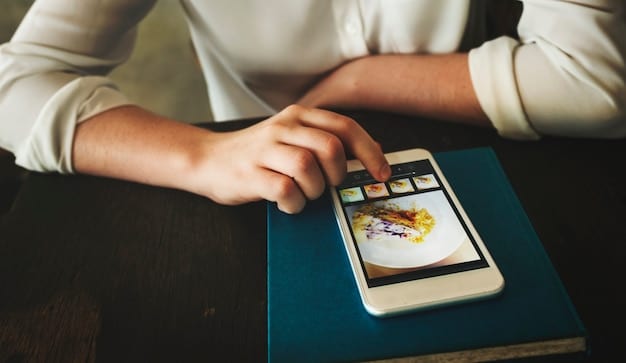 A person holding a smartphone, scrolling through a review website or social media feed displaying a film reel icon, representing digital consumption of reviews.
