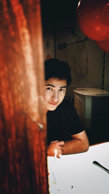 A young Japanese actor engrossed in reading a script on a film set, spotlight shining on his focused face, conveying dedication and rising talent.