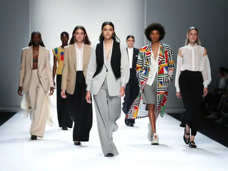 Models on a runway displaying modern gender-fluid clothing styles
